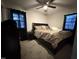 Comfortable bedroom featuring a ceiling fan, natural light, and carpeted floors at 109 Pine St, Dunn, NC 28334