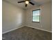 Cozy bedroom with plush carpeting, a ceiling fan, and a window providing ample natural light at 109 Pine St, Dunn, NC 28334