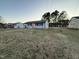 Spacious front yard with a one-story home, surrounded by mature trees at 109 Pine St, Dunn, NC 28334