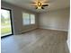 Bright living room features new floors, modern ceiling fan, and a large window letting in natural light at 109 Pine St, Dunn, NC 28334