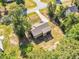 Aerial view of home highlighting the spacious partially fenced backyard with mature trees, screened porch, and fire pit at 114 Cherryhill Dr, Four Oaks, NC 27524