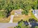 Aerial view of the home with a long driveway, spacious yard, mature trees, and outbuilding at 114 Cherryhill Dr, Four Oaks, NC 27524