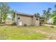 Well-maintained backyard featuring a fire pit, mature trees, and a partially fenced yard at 114 Cherryhill Dr, Four Oaks, NC 27524