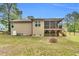 Spacious backyard featuring a screened-in porch, a fire pit, and mature trees for added privacy at 114 Cherryhill Dr, Four Oaks, NC 27524