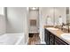 Bathroom with dual sink vanity, walk-in closet, and combination tub and shower at 114 Cherryhill Dr, Four Oaks, NC 27524