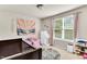 Bright bedroom featuring a crib, large window and colorful wall decor at 114 Cherryhill Dr, Four Oaks, NC 27524