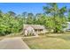 Inviting single-story home showcases a well-maintained lawn, long driveway, and peaceful, wooded surroundings at 114 Cherryhill Dr, Four Oaks, NC 27524