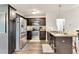 Well-equipped kitchen with stainless steel appliances, dark cabinetry, and functional layout, offering ample storage and workspace at 114 Cherryhill Dr, Four Oaks, NC 27524