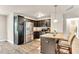 Functional kitchen with stainless steel appliances, dark cabinetry, and breakfast bar, offering a convenient gathering spot at 114 Cherryhill Dr, Four Oaks, NC 27524