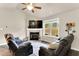 Cozy living room featuring plush seating, a fireplace, and a large window with views of the outdoor scenery at 114 Cherryhill Dr, Four Oaks, NC 27524