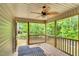 Relaxing screened porch with wood flooring and a decorative ceiling fan overlooking the backyard at 114 Cherryhill Dr, Four Oaks, NC 27524