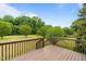 Wooden deck with railing overlooking a lush, green backyard at 114 Lynnville Ct, Lillington, NC 27546