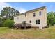Spacious backyard featuring a wooden deck and lush green grass at 114 Lynnville Ct, Lillington, NC 27546