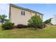 Side view of the large back yard showing a small wooden deck at 114 Lynnville Ct, Lillington, NC 27546