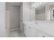 Bright bathroom with a white vanity, large mirror, and tile floors at 114 Lynnville Ct, Lillington, NC 27546