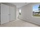 This carpeted bedroom features a closet, complemented by two windows offering views of the outdoors at 114 Lynnville Ct, Lillington, NC 27546