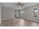 Spacious bedroom with ceiling fan, two large windows, and wood-look flooring at 114 Lynnville Ct, Lillington, NC 27546
