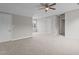 Spacious bedroom featuring neutral carpet, ceiling fan, multiple windows, and a walk-in closet at 114 Lynnville Ct, Lillington, NC 27546