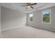 Spacious carpeted bedroom with windows that provide ample natural light and scenic green views at 114 Lynnville Ct, Lillington, NC 27546