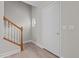 Welcoming entryway featuring wood-look floors, white door, staircase, and a charming porthole window at 114 Lynnville Ct, Lillington, NC 27546