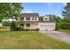 Inviting two-story home boasts a classic design, a covered porch, and an attached two-car garage at 114 Lynnville Ct, Lillington, NC 27546