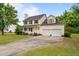 Traditional home with a covered porch, a two-car garage, and a well-maintained front yard at 114 Lynnville Ct, Lillington, NC 27546