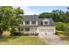 Charming two-story home featuring a welcoming front porch and an attached two-car garage at 114 Lynnville Ct, Lillington, NC 27546