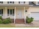 Close-up of the front porch, showcasing the white railings, brick steps, and unique octagon window at 114 Lynnville Ct, Lillington, NC 27546