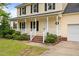 Charming front porch with white railings, brick steps, and nicely landscaped features at 114 Lynnville Ct, Lillington, NC 27546