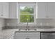 Bright kitchen featuring granite counters, stainless steel appliances, and a window with a view of nature at 114 Lynnville Ct, Lillington, NC 27546