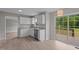 Kitchen featuring white cabinets, granite countertops, a stainless steel sink, and access to the back deck at 114 Lynnville Ct, Lillington, NC 27546