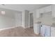 Kitchen area with white cabinets, granite countertops, and new range hood in box at 114 Lynnville Ct, Lillington, NC 27546