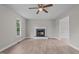 Inviting living room boasts wood-look flooring, a fireplace, and windows for ample natural light at 114 Lynnville Ct, Lillington, NC 27546