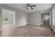 Open-concept living area with wood-look flooring, access to the staircase, and view to the dining room at 114 Lynnville Ct, Lillington, NC 27546