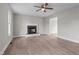 Living room featuring a fireplace, wood-look flooring, and an open doorway to the kitchen at 114 Lynnville Ct, Lillington, NC 27546