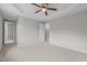 Neutral main bedroom featuring a ceiling fan, tray ceiling, and carpeted floors at 114 Lynnville Ct, Lillington, NC 27546