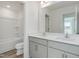 Bathroom with double sink vanity, framed mirror, and tub with white tile at 1248 Randwick Valley Ct, Zebulon, NC 27597