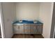 Bathroom vanity with double sinks, grey cabinets, quartz countertop covered in plastic wrap at 1248 Randwick Valley Ct, Zebulon, NC 27597