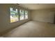 Bedroom with unfinished flooring, bright windows with neighborhood views, and white trim at 1248 Randwick Valley Ct, Zebulon, NC 27597
