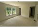 Bedroom with lake view, two windows, unfinished flooring, and a closet at 1248 Randwick Valley Ct, Zebulon, NC 27597