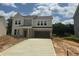 New two-story home with brick accents, a large driveway, and an attached two-car garage at 1248 Randwick Valley Ct, Zebulon, NC 27597