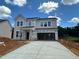 Two-story home with neutral siding, large windows, and a spacious driveway for convenient parking at 1248 Randwick Valley Ct, Zebulon, NC 27597