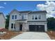 Two-story home with gray siding, black roof, and visible construction materials at 1248 Randwick Valley Ct, Zebulon, NC 27597