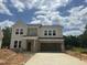 Two-story home featuring mixed brick and siding, attached garage, and a concrete driveway at 1248 Randwick Valley Ct, Zebulon, NC 27597