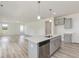Bright kitchen features gray cabinets, white countertops, stainless appliances, and a center island at 1248 Randwick Valley Ct, Zebulon, NC 27597