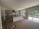 Spacious kitchen featuring gray cabinets, central island, and sliding glass door at 1248 Randwick Valley Ct, Zebulon, NC 27597