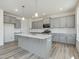 View of kitchen with gray cabinets, white countertops, stainless appliances, and a center island at 1248 Randwick Valley Ct, Zebulon, NC 27597