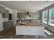 Under construction kitchen with gray cabinetry, center island and large windows at 1248 Randwick Valley Ct, Zebulon, NC 27597