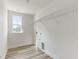 Functional laundry room with wood floors and a bright window at 1248 Randwick Valley Ct, Zebulon, NC 27597