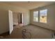Bright living room with french doors, large windows, and unfinished flooring at 1248 Randwick Valley Ct, Zebulon, NC 27597